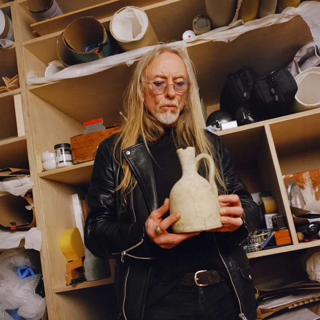 Guggi holding vase in studio